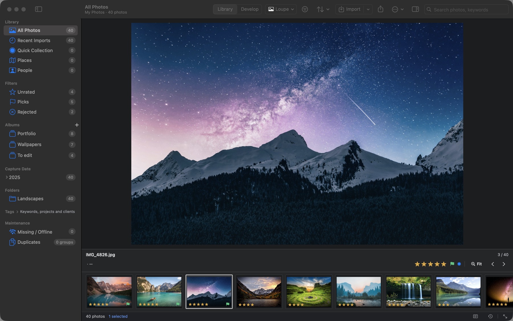 Loupe view: the Milky Way over snowy mountains, with the filmstrip below